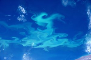 Swirls of plae blue on bright blue background